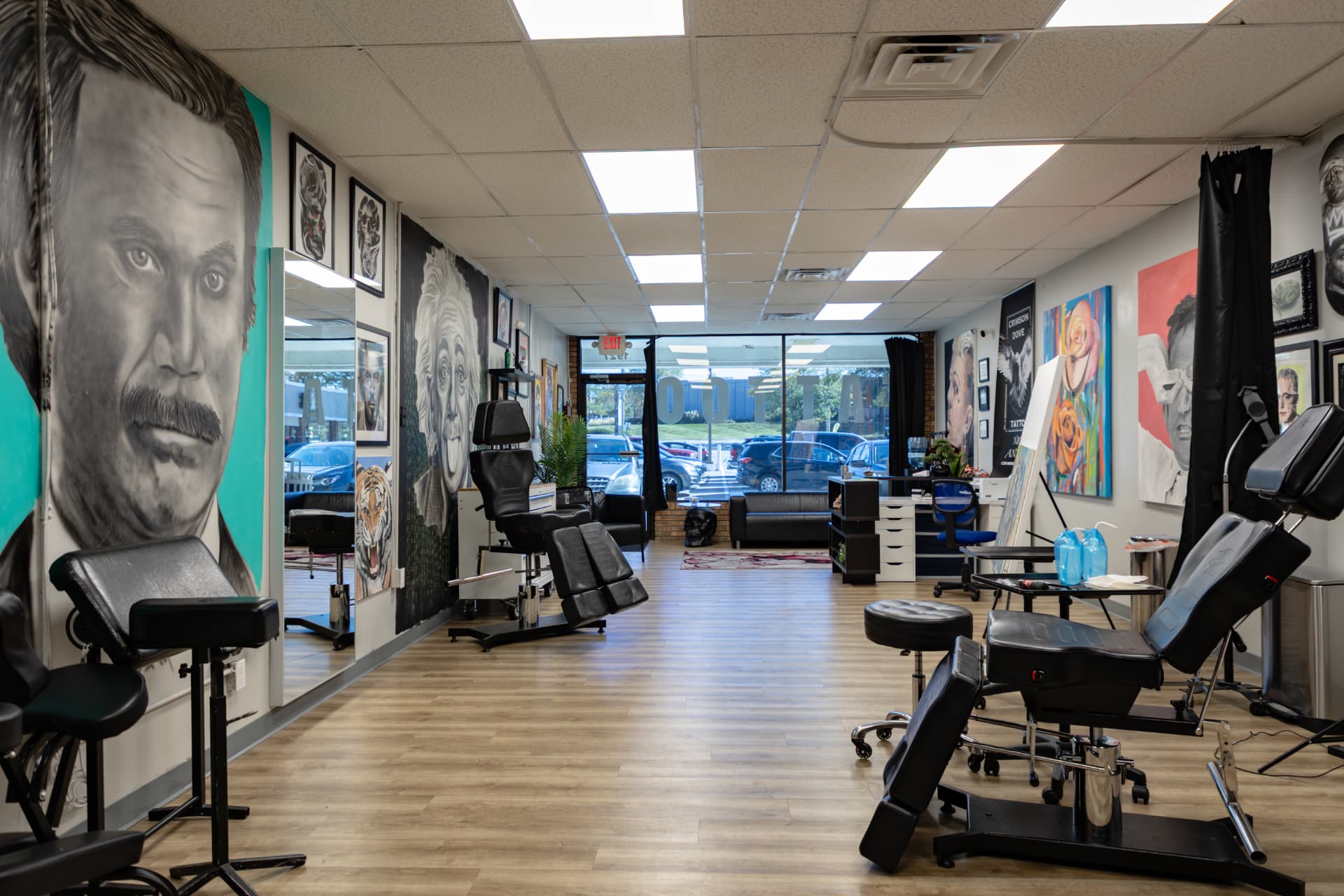 Crimson Dove Tattoo studio seen from the back wall toward the glass front entrance and parking lot
